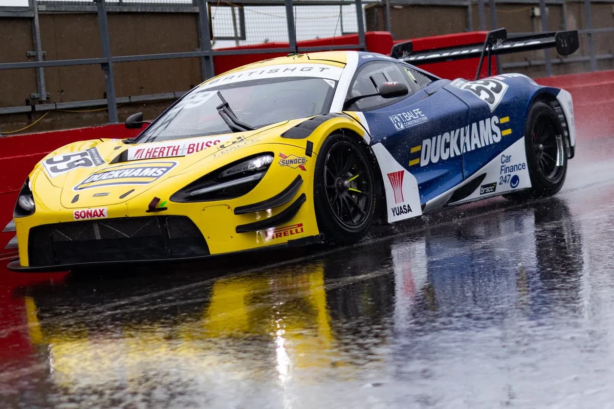 A Duckhams-liveried McLaren GT3 at speed on a wet circuit.