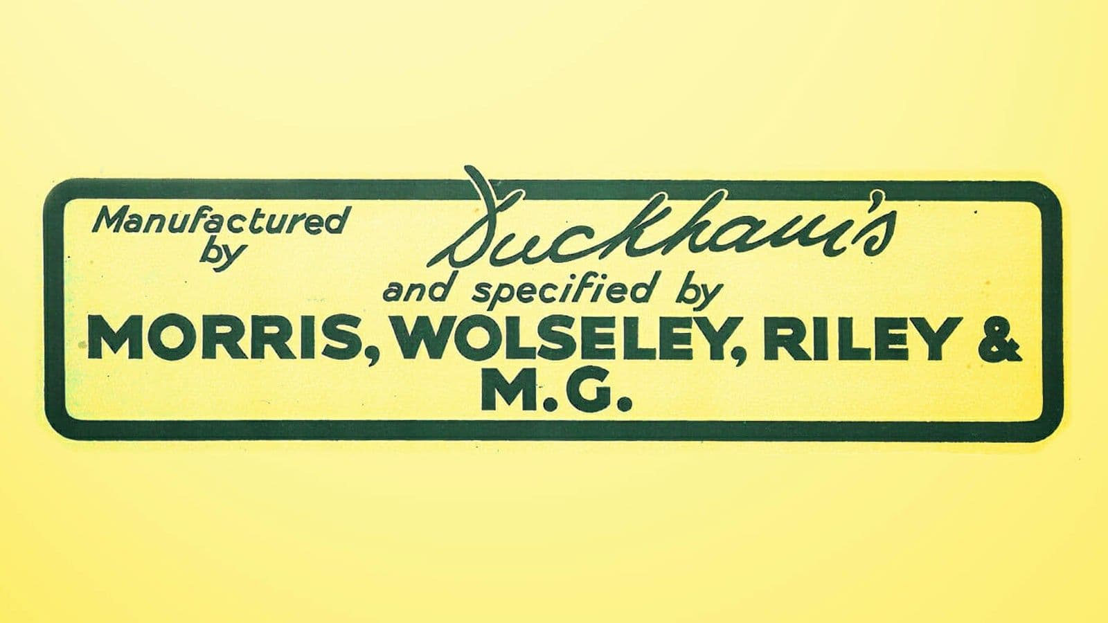 A yellow enamel sign reading "Manufactured by Duckham's and specified by Morris, Wolseley, Riley & M.G."
