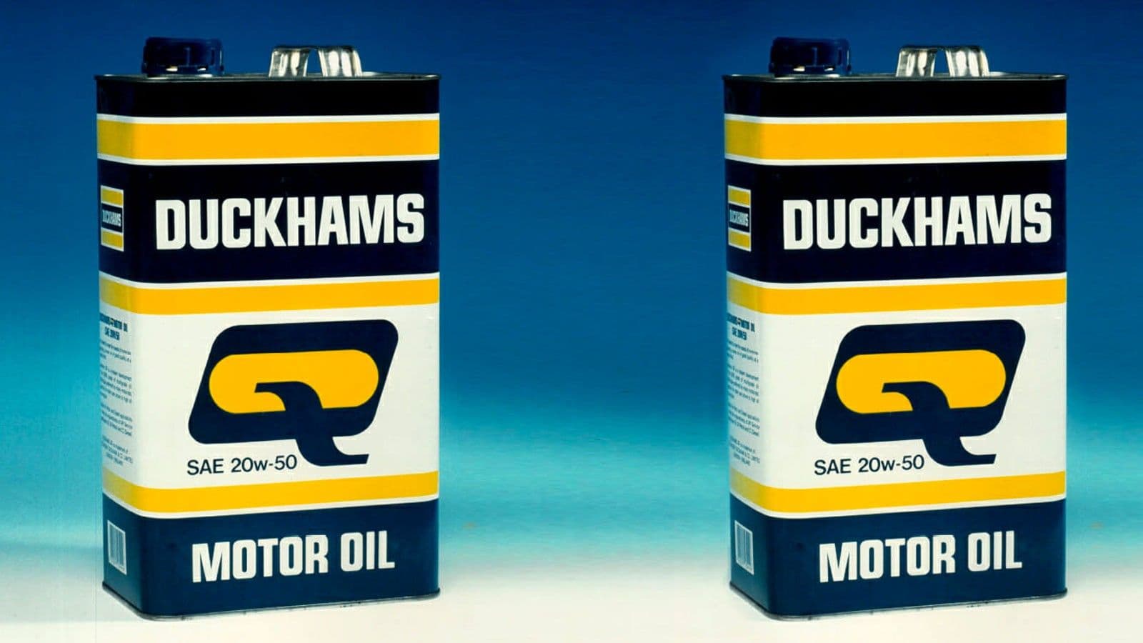 Two Duckhams Q motor oil cans in the yellow and blue livery, marked SAE 20w-50.