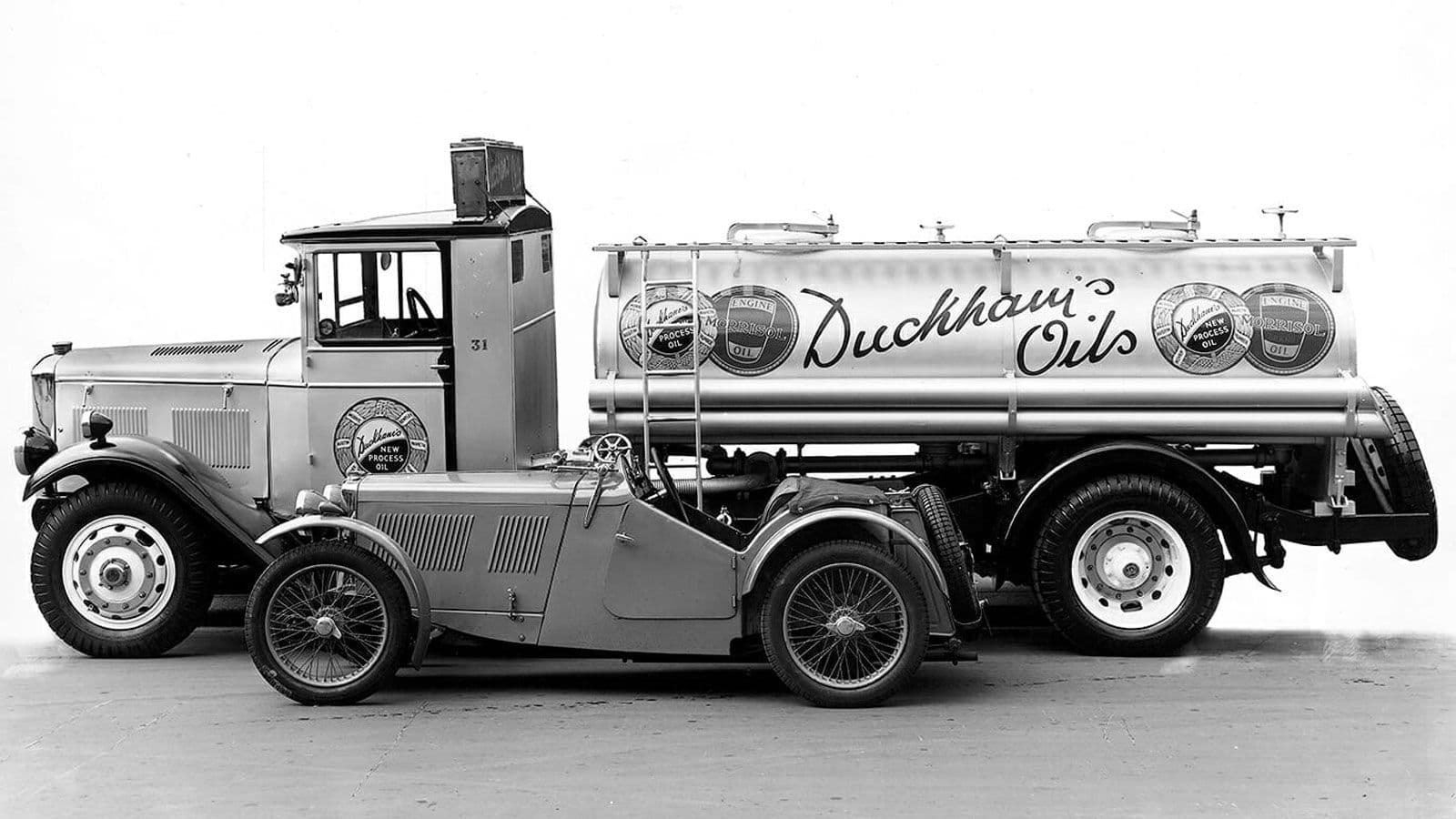A 1920s tanker lorry with "Duckham's Oils" painted in script across its cylindrical tank.